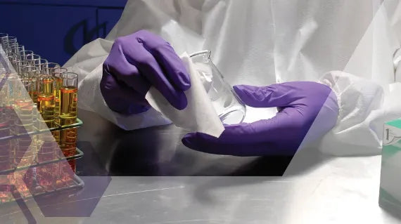 Cleaning a beaker using a sterile wipe.