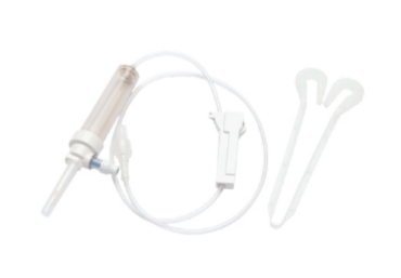 A white plastic IV or fluid transfer set with a clear cylindrical chamber, connected tubing, a small white rectangular component, and two curved white plastic accessories, shown on a plain white background.